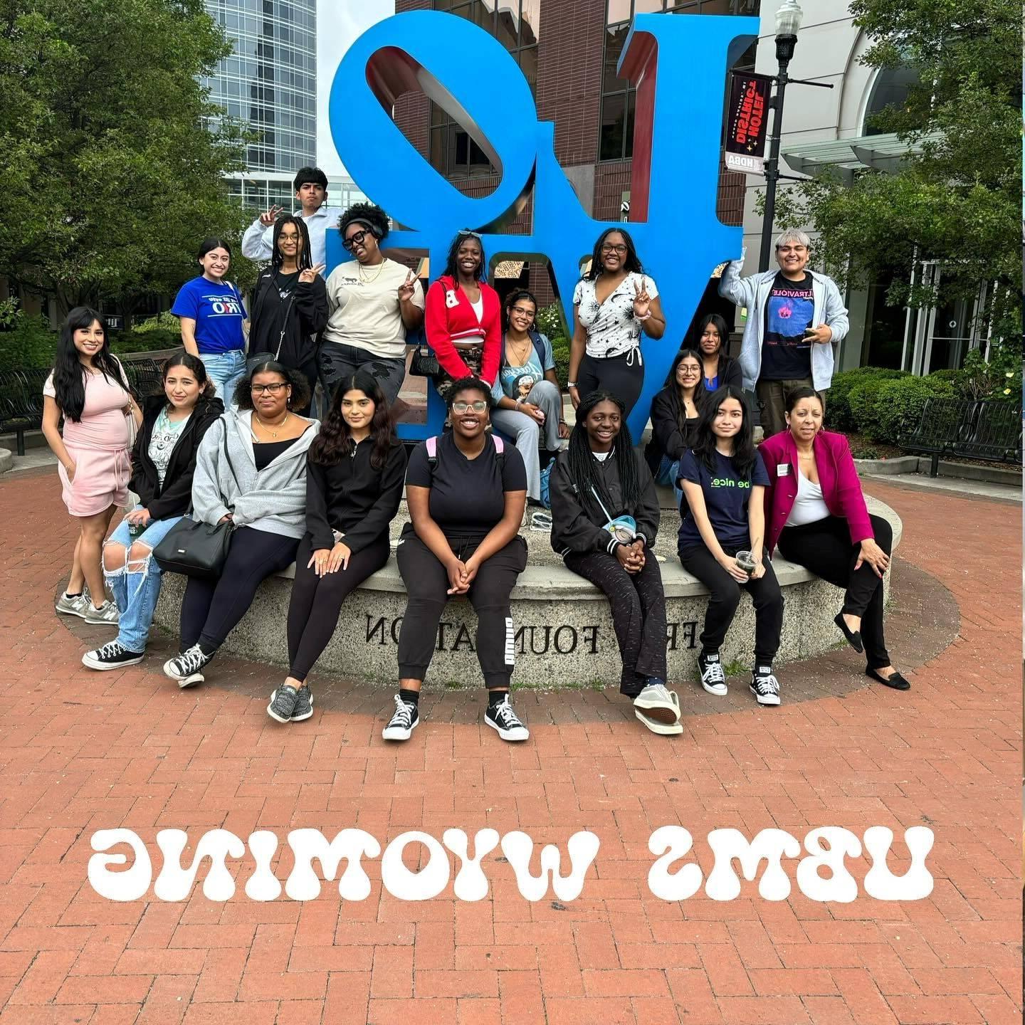 students in front of the LOVE sign